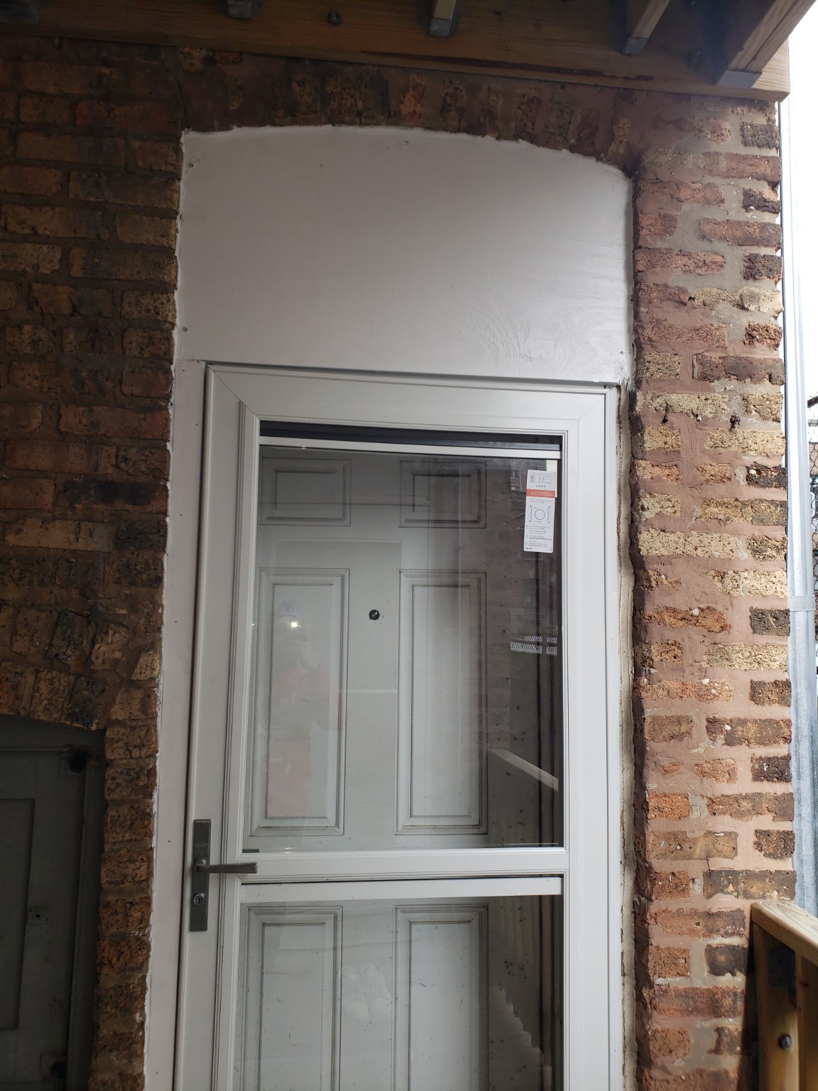 Completed white storm door installation