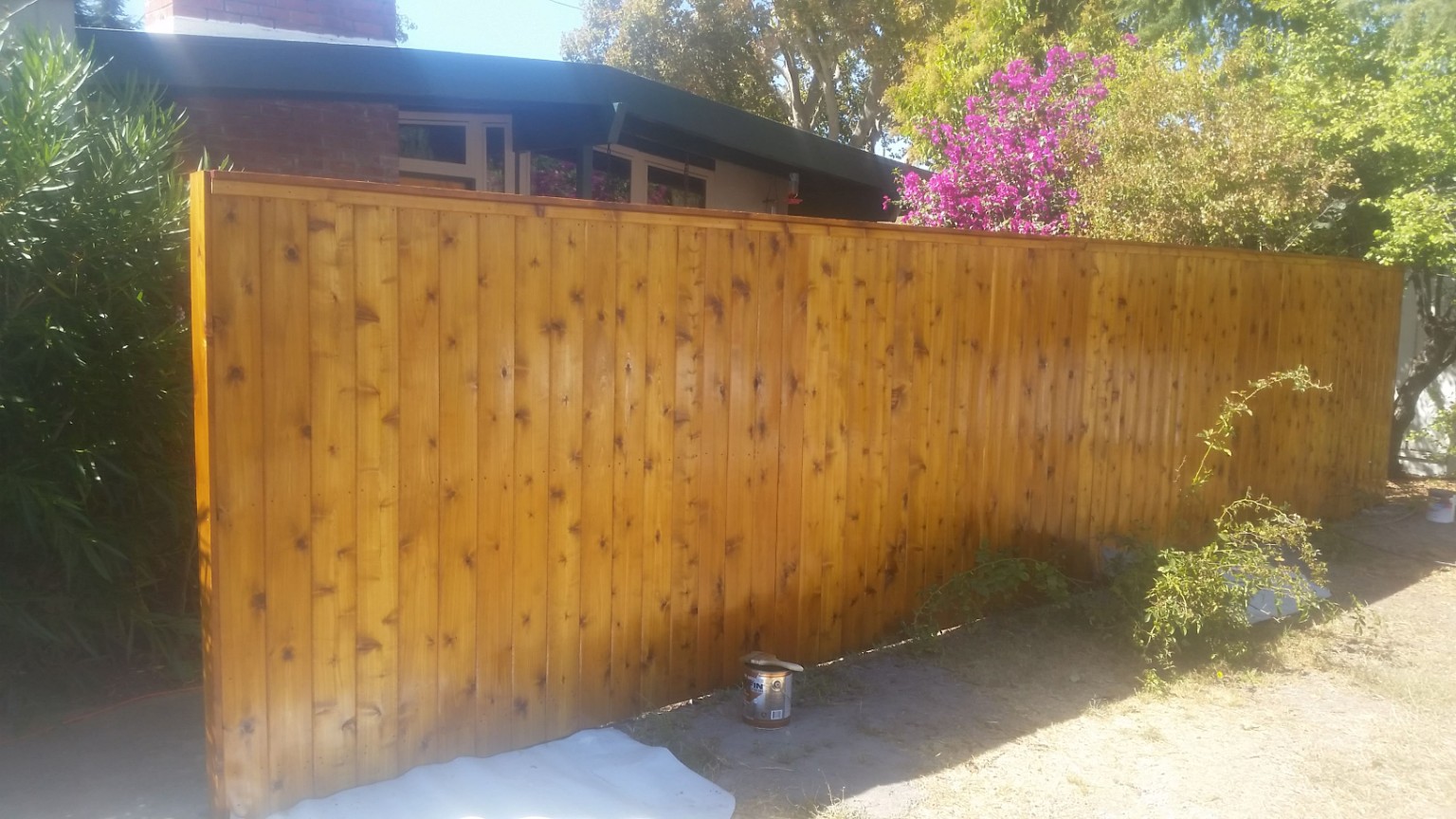 Wood privacy fence with completed protective finish