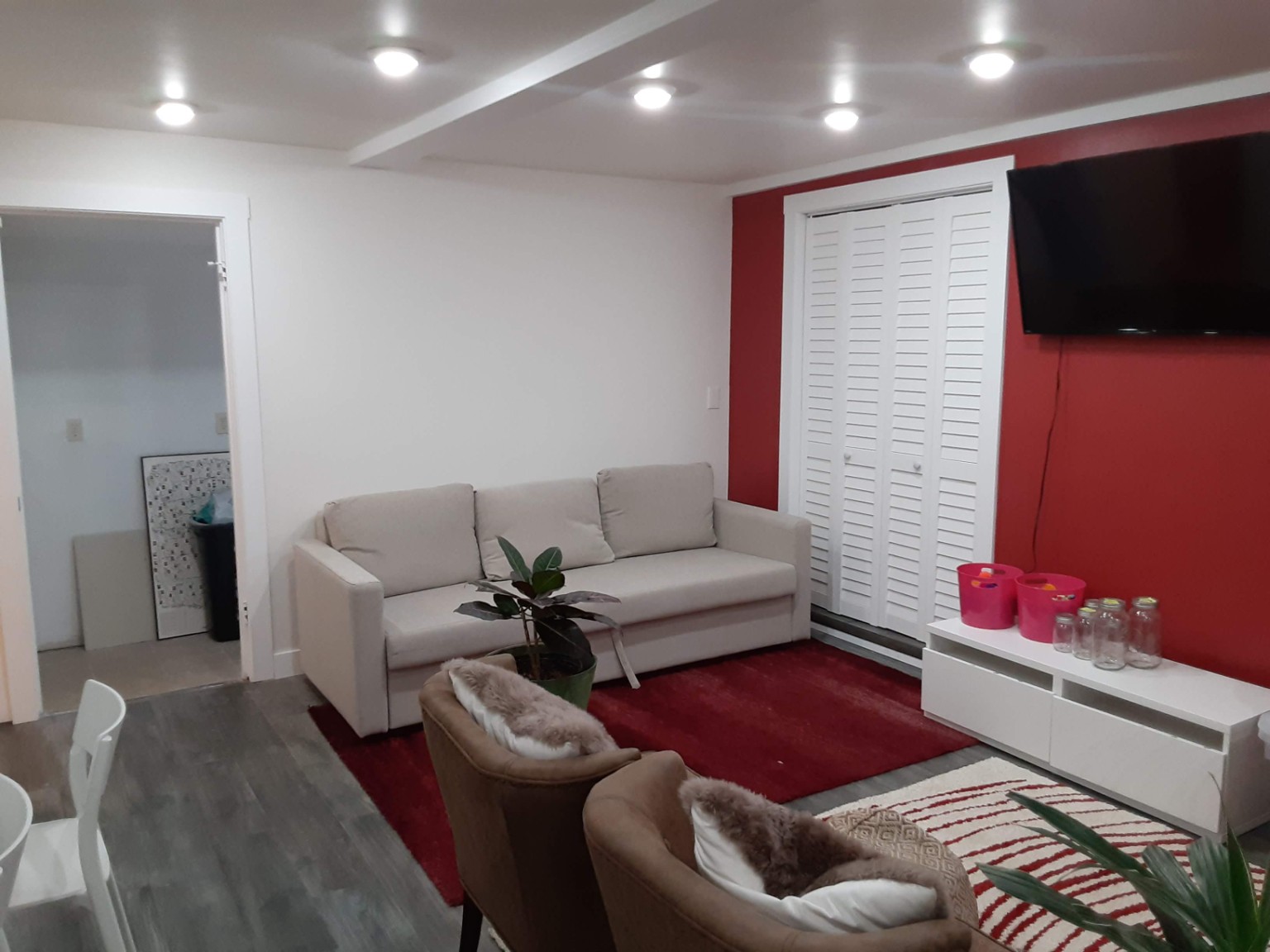 Finished living area with red accents and new flooring
